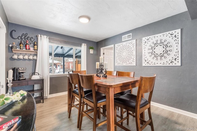 dining space with hardwood / wood-style floors