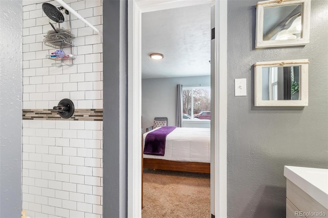 bathroom featuring vanity and a tile shower