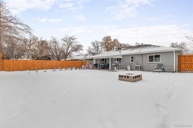 snow covered house with central AC unit