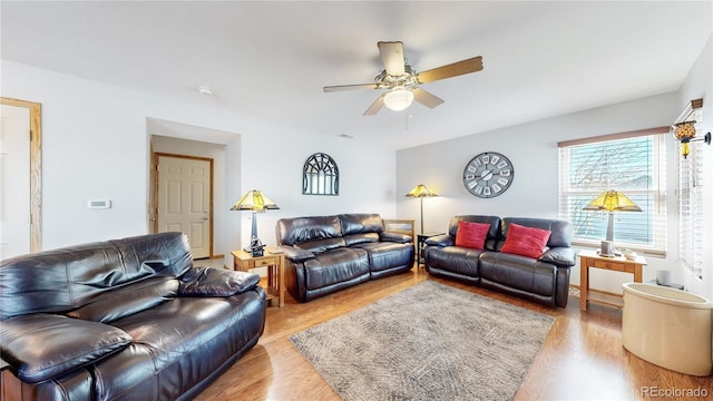 living room featuring ceiling fan and light hardwood / wood-style flooring