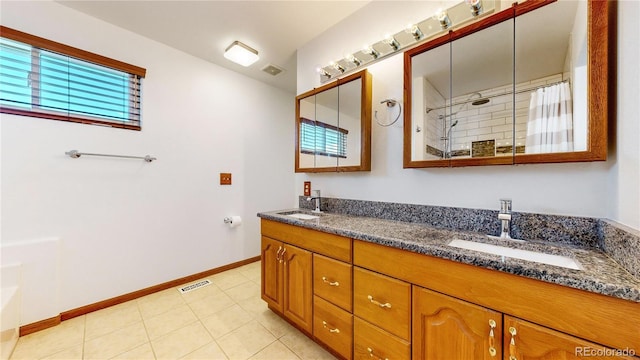 bathroom featuring walk in shower, tile patterned flooring, and vanity