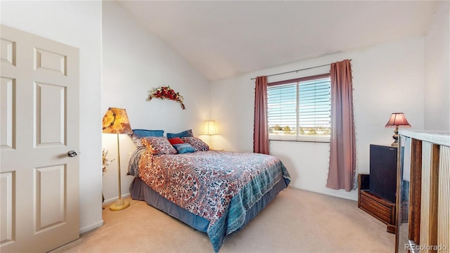 bedroom with carpet and vaulted ceiling