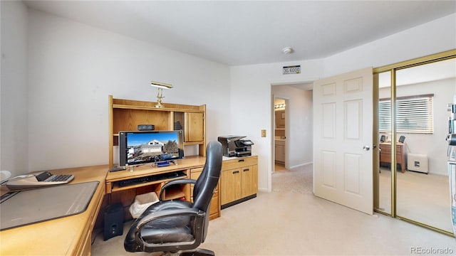 office area featuring light colored carpet