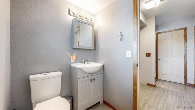 bathroom featuring toilet and vanity