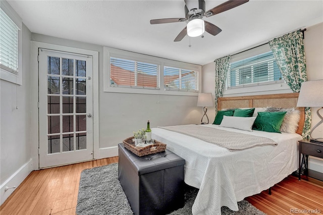 bedroom with baseboards, ceiling fan, and wood finished floors