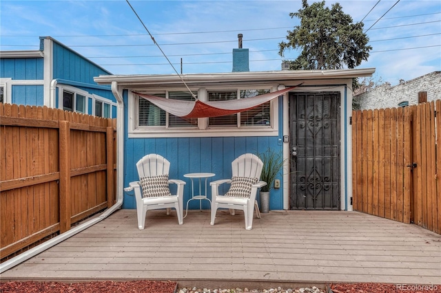 wooden terrace featuring fence