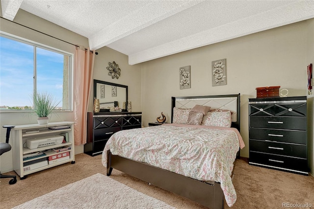 carpeted bedroom featuring multiple windows and a textured ceiling