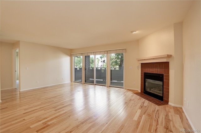 unfurnished living room with a fireplace and light hardwood / wood-style flooring