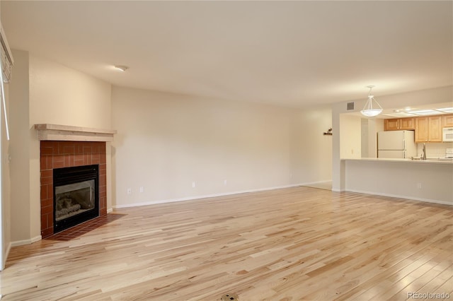 unfurnished living room with light hardwood / wood-style floors