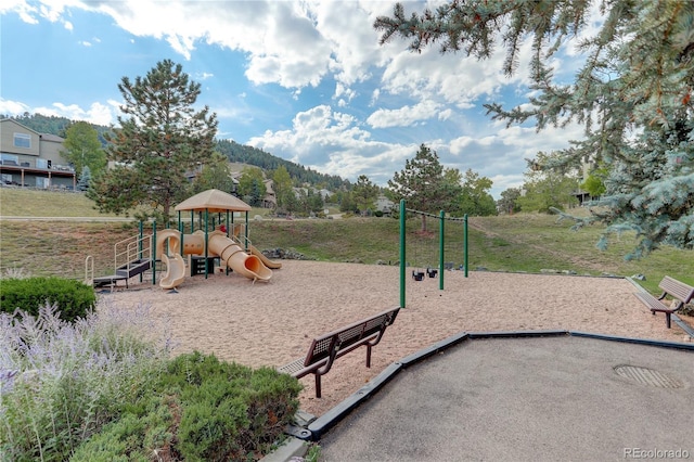 view of jungle gym with a mountain view