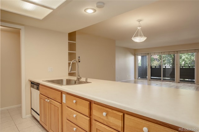 kitchen featuring light brown cabinetry, decorative light fixtures, dishwasher, sink, and light tile patterned floors