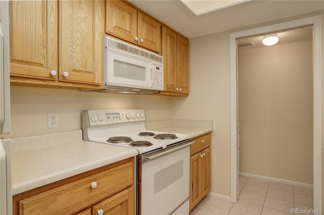 kitchen with white appliances and light tile patterned floors