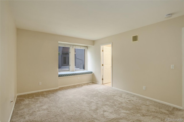 empty room featuring light colored carpet