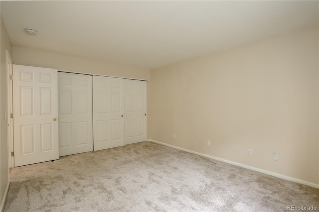 unfurnished bedroom featuring carpet floors and a closet