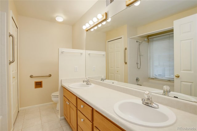 bathroom with vanity, tile patterned floors, and toilet