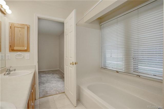 bathroom with vanity, a washtub, and tile patterned floors