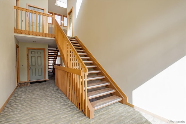 staircase with a high ceiling