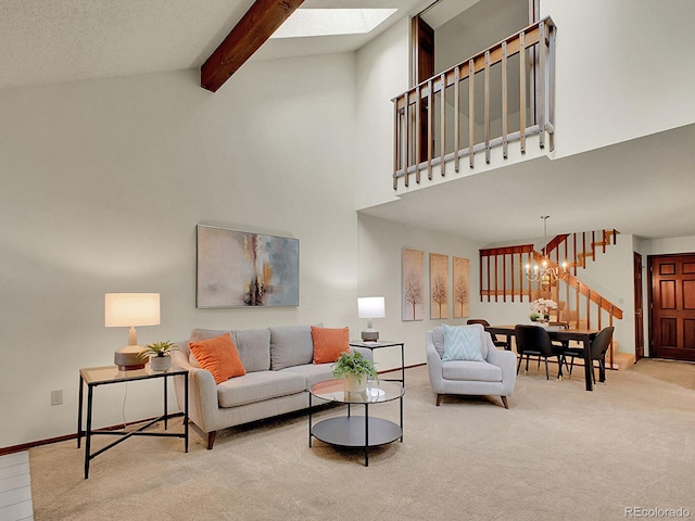 7781 S Curtice Dr Unit D, Littleton, CO 80120 - carpeted living room with a chandelier, high vaulted ceiling, a skylight, beam ceiling, and stairs