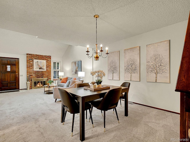 7781 S Curtice Dr Unit D, Littleton, CO 80120 - carpeted dining space featuring a chandelier, vaulted ceiling, a fireplace, and a textured ceiling