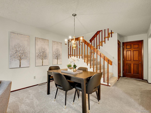 7781 S Curtice Dr Unit D, Littleton, CO 80120 - dining area with light colored carpet, a chandelier, stairs, and a textured ceiling