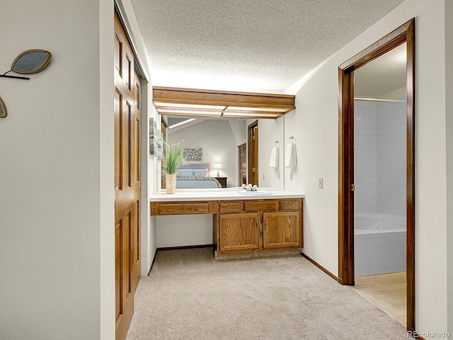 7781 S Curtice Dr Unit D, Littleton, CO 80120 - ensuite bathroom with vanity, tub / shower combination, a textured ceiling, and carpet floors