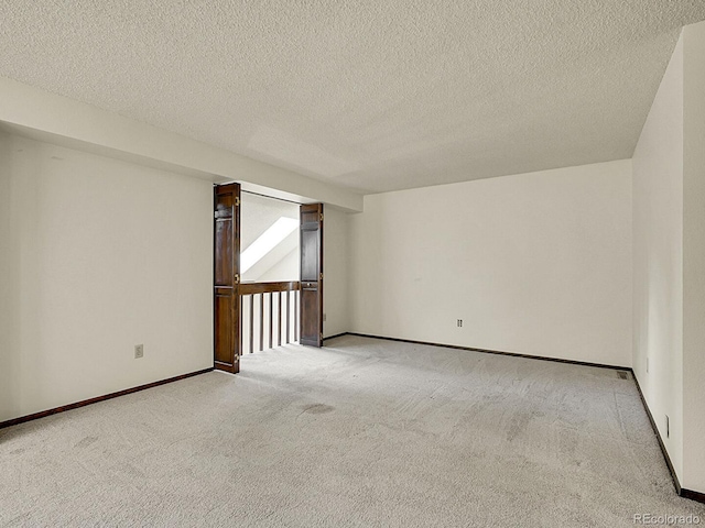 7781 S Curtice Dr Unit D, Littleton, CO 80120 - unfurnished room featuring light colored carpet and a textured ceiling