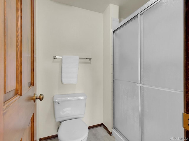 7781 S Curtice Dr Unit D, Littleton, CO 80120 - bathroom with toilet and a shower stall