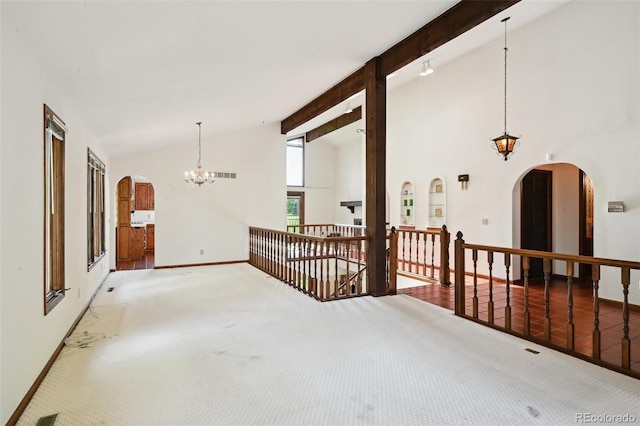11621 Shoshone Way, Denver, CO 80234 - carpeted spare room with a chandelier, beamed ceiling, high vaulted ceiling, and arched walkways
