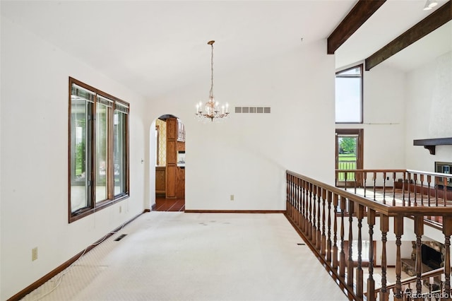 11621 Shoshone Way, Denver, CO 80234 - hallway featuring carpet flooring, arched walkways, vaulted ceiling, and a chandelier