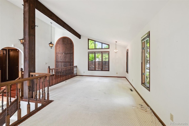 11621 Shoshone Way, Denver, CO 80234 - empty room featuring carpet, arched walkways, beam ceiling, and high vaulted ceiling