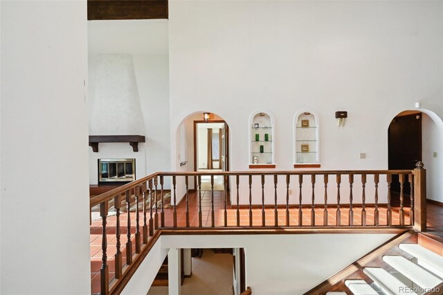 11621 Shoshone Way, Denver, CO 80234 - stairs featuring built in shelves, arched walkways, and a towering ceiling