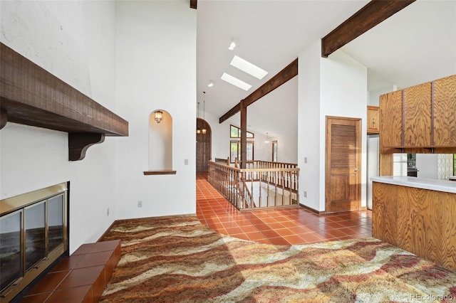 11621 Shoshone Way, Denver, CO 80234 - kitchen featuring high vaulted ceiling, a skylight, beamed ceiling, and tile patterned floors