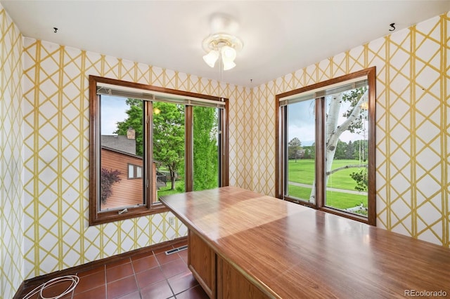 11621 Shoshone Way, Denver, CO 80234 - dining area featuring wallpapered walls and dark tile patterned flooring