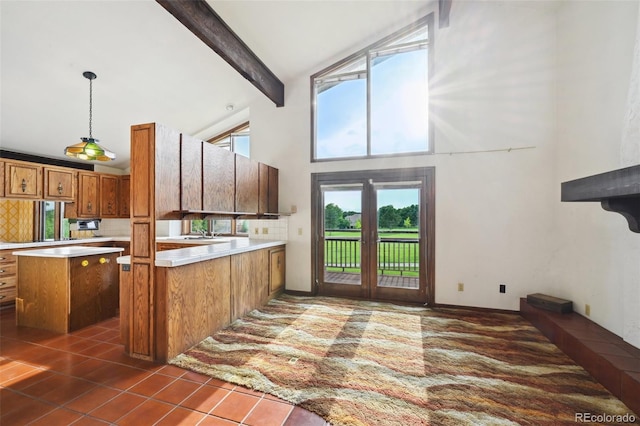 11621 Shoshone Way, Denver, CO 80234 - kitchen featuring high vaulted ceiling, brown cabinets, beamed ceiling, light countertops, and a peninsula
