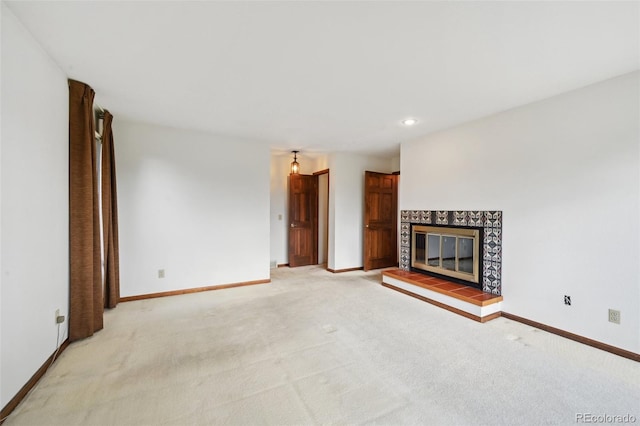11621 Shoshone Way, Denver, CO 80234 - unfurnished living room featuring light colored carpet, a tiled fireplace, and recessed lighting