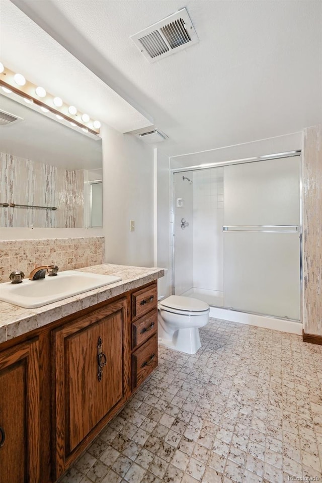 11621 Shoshone Way, Denver, CO 80234 - full bath with vanity, tile patterned floors, a stall shower, and tasteful backsplash