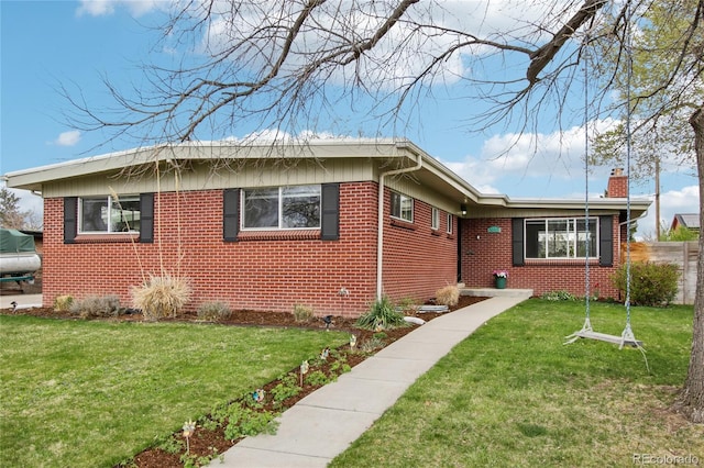 6188 S Westview St, Littleton, CO 80120 - view of front of property featuring brick siding, fence, a chimney, and a front lawn