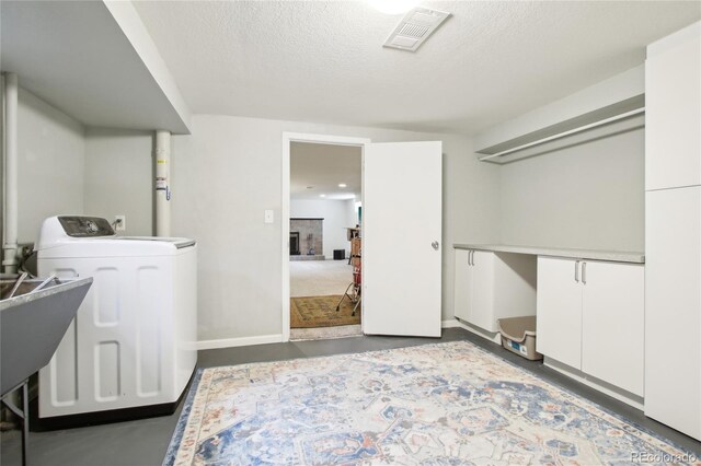 6188 S Westview St, Littleton, CO 80120 - laundry room with laundry area, a textured ceiling, visible vents, baseboards, and washer / dryer