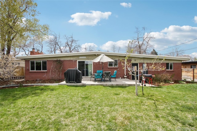 6188 S Westview St, Littleton, CO 80120 - rear view of house with brick siding, fence, a chimney, and a patio