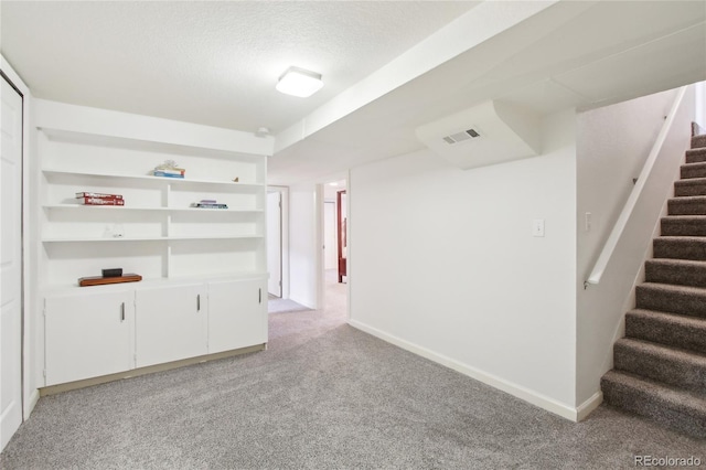 6188 S Westview St, Littleton, CO 80120 - empty room featuring stairway, baseboards, a textured ceiling, and light colored carpet