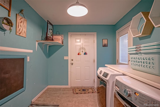 laundry area with washing machine and clothes dryer and tile patterned floors