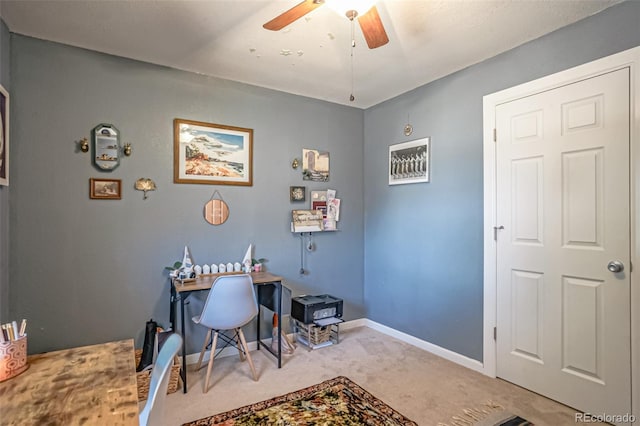 dining space featuring ceiling fan and light carpet