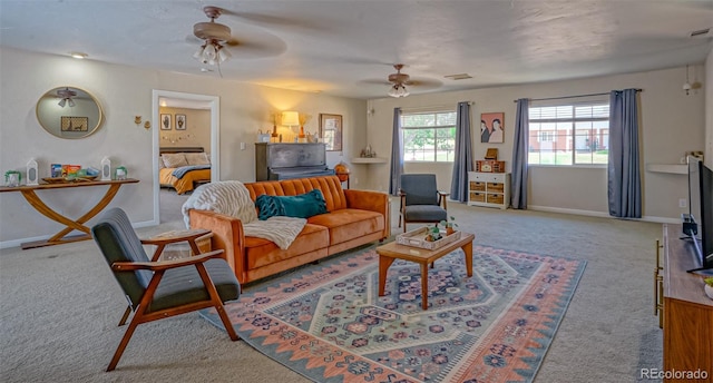 living room featuring light colored carpet and ceiling fan