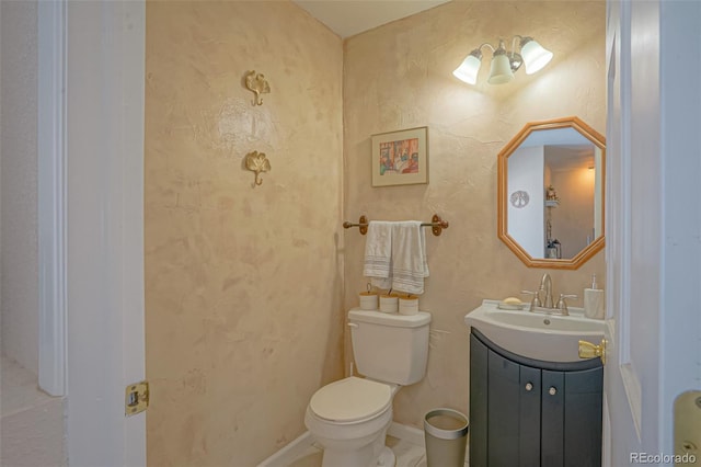 bathroom featuring toilet and vanity