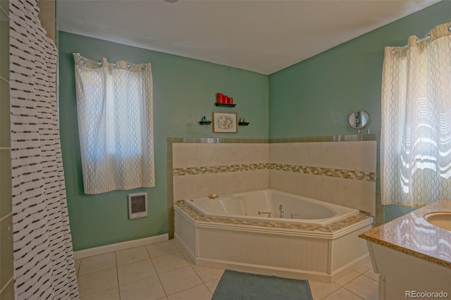 bathroom with tile patterned flooring, a bathing tub, heating unit, and vanity