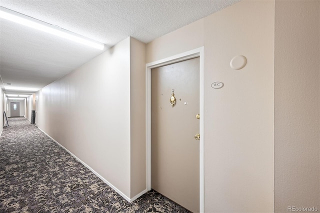 350 S Clinton St Unit 8C, Denver, CO 80247 - hallway featuring carpet flooring and a textured ceiling