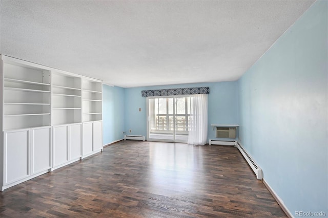 350 S Clinton St Unit 8C, Denver, CO 80247 - unfurnished room with dark wood finished floors, baseboard heating, a wall unit AC, and a textured ceiling