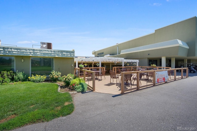 350 S Clinton St Unit 8C, Denver, CO 80247 - surrounding community with a lawn, outdoor dining space, a wooden deck, and a pergola