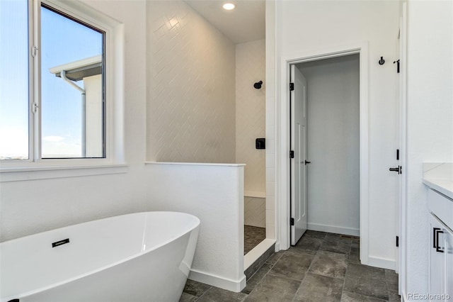 16990 Early Light Dr, Colorado Springs, CO 80908 - bathroom featuring baseboards, a tile shower, a soaking tub, and vanity
