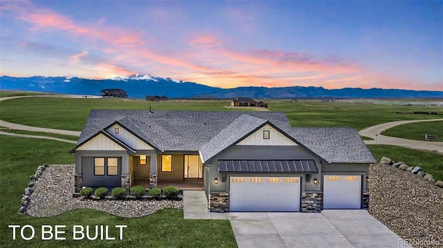 16990 Early Light Dr, Colorado Springs, CO 80908 - view of front of property with an attached garage, a mountain view, a yard, and stone siding